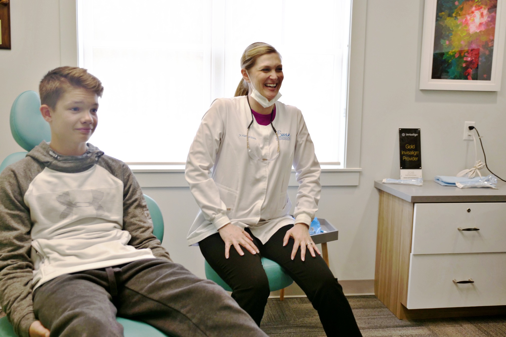 Dr Swan laughing and helping patient