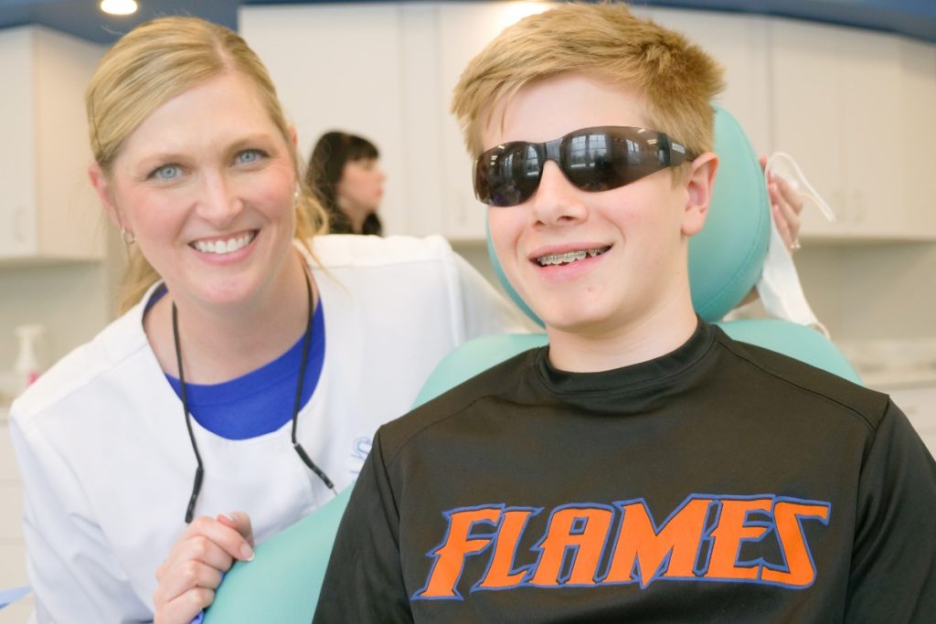 Dr. Swan posing with a young patient