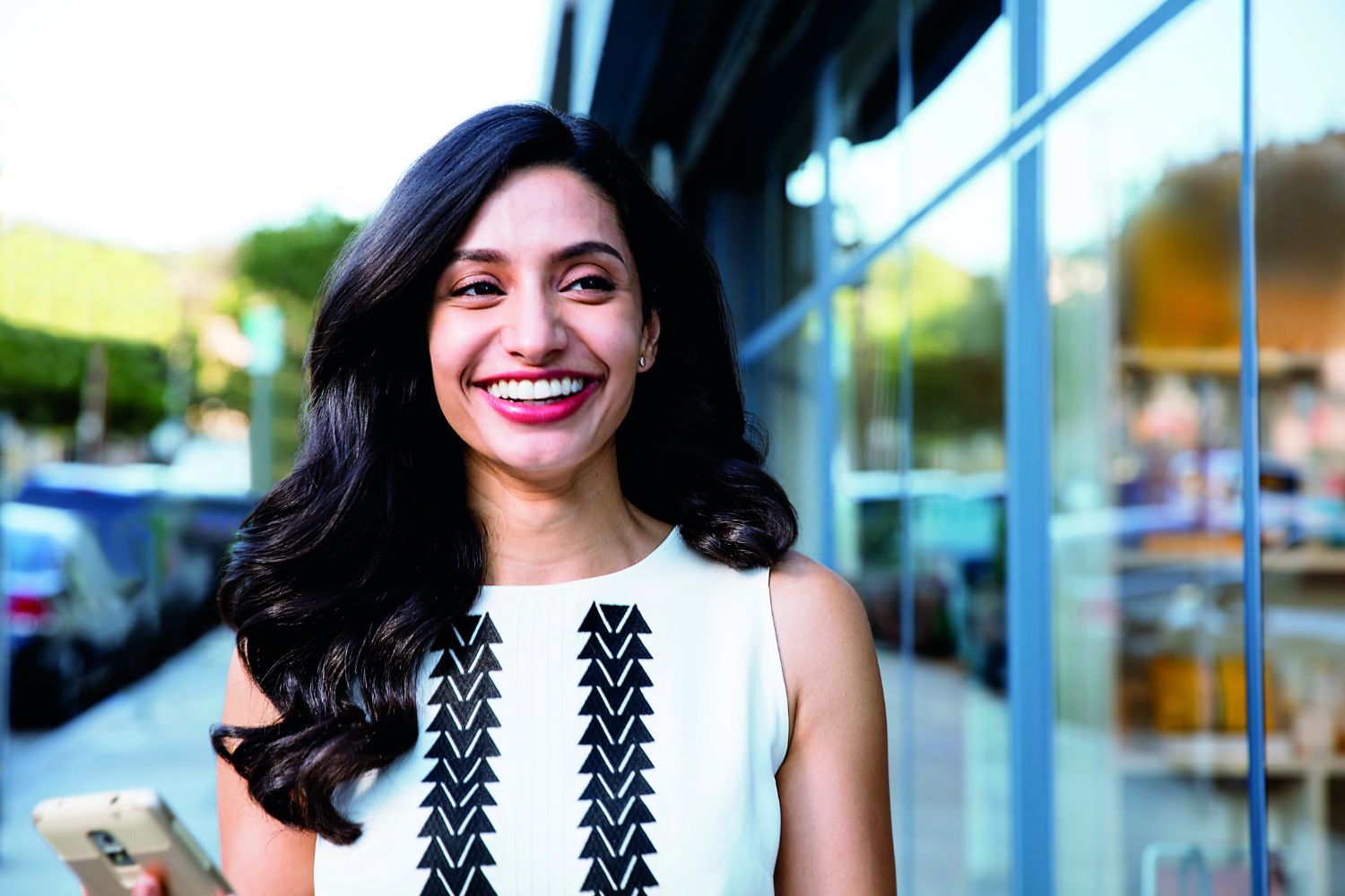 Adult with Invisalign smiling and walking