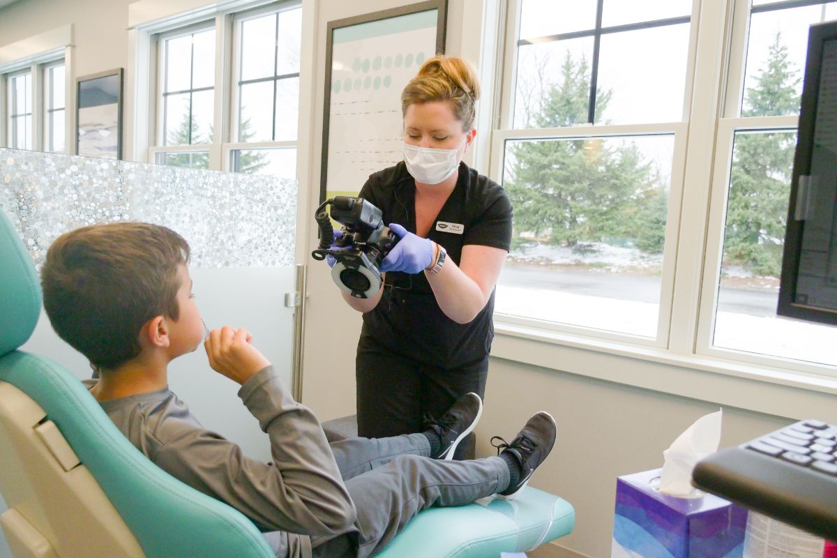 assistant taking photo of teeth
