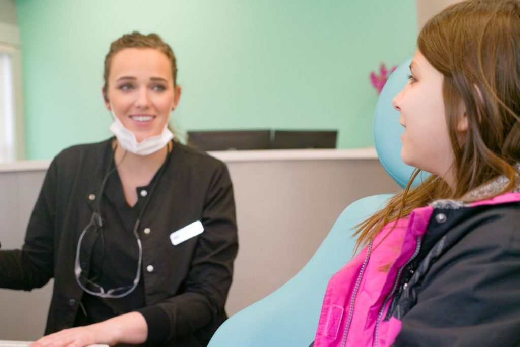 assistant talking to patient